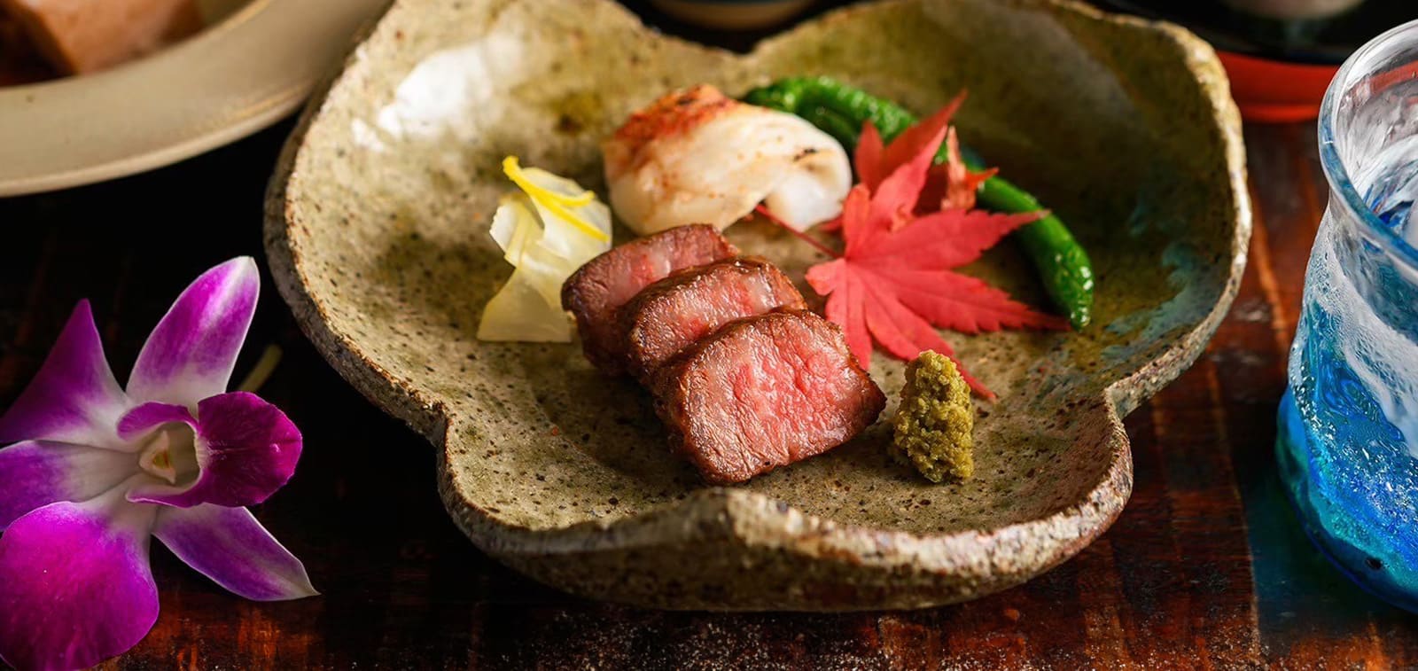 Okinawan kaiseki dish served with blue glass at Akasaka Tantei
