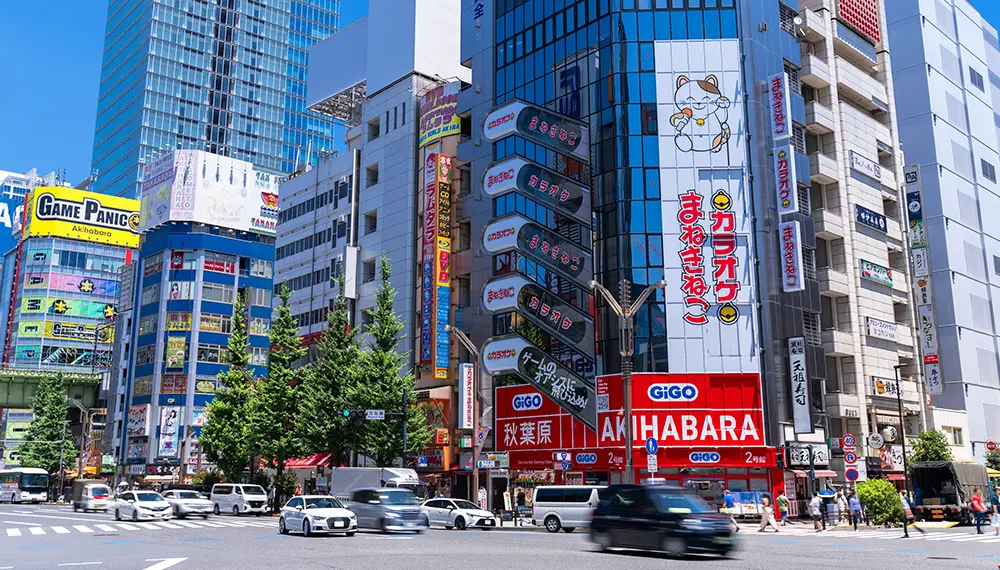 Arcades and game signs around Akihabara under a blue sky