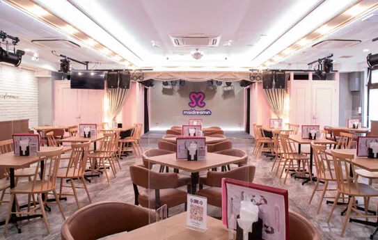 Pink and white live restaurant interior with stage at maidreamin Heaven's Gate