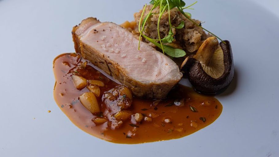 French meat course with mushrooms and sauce at Aile Blanche
