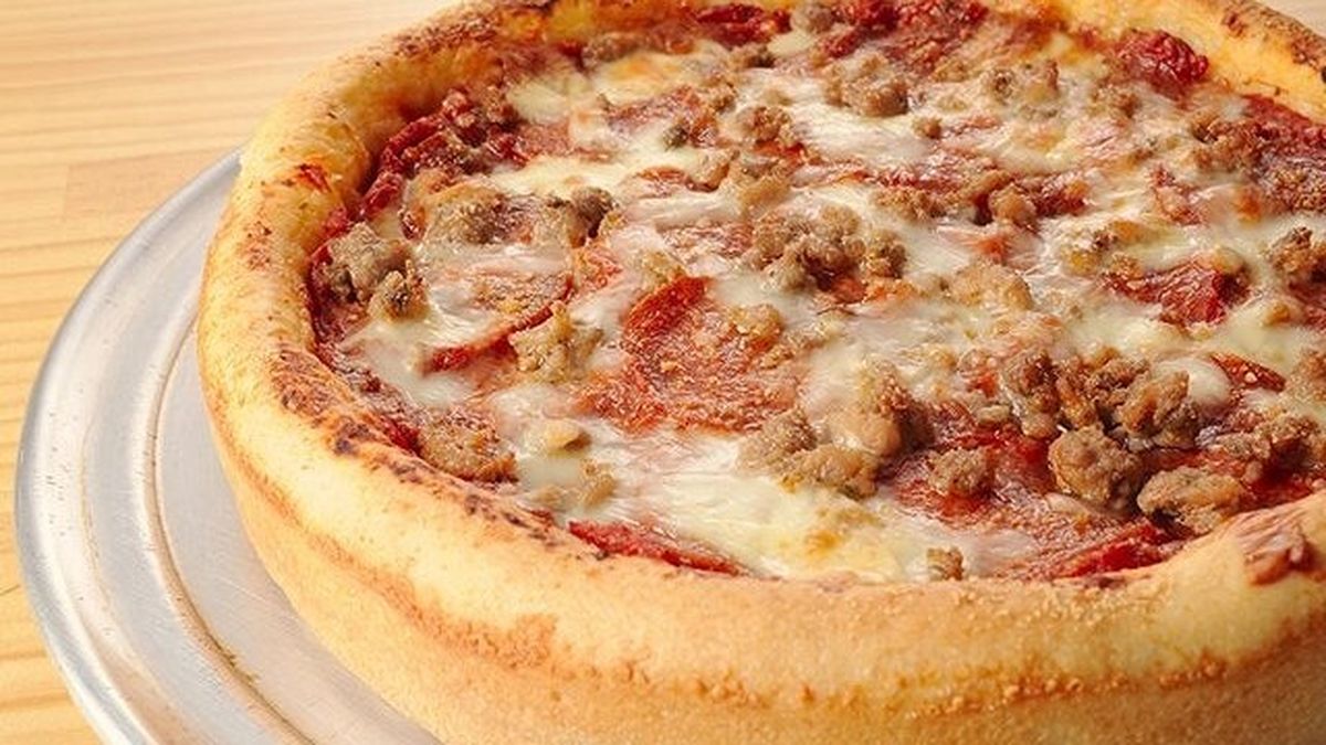 Thick Chicago-style deep-dish pizza with meat and melted cheese at DevilCraft Jiyugaoka
