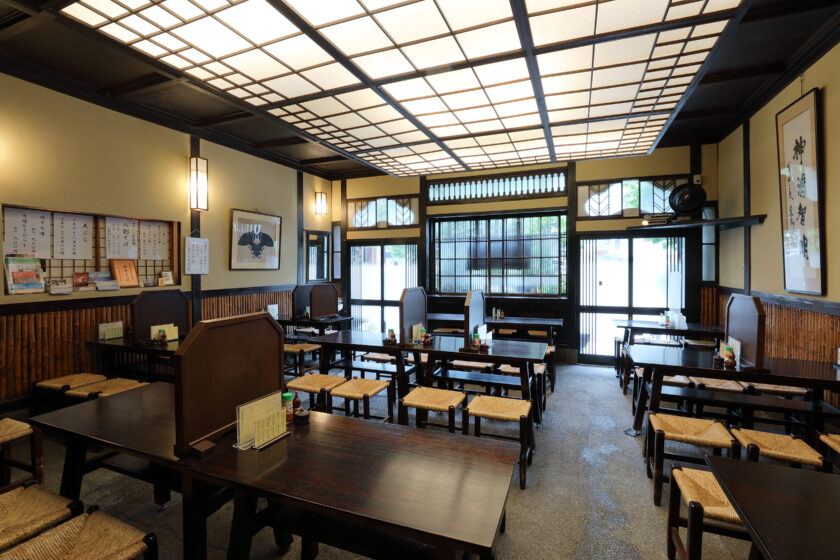 Traditional wooden dining room with lattice ceiling at Kanda Matsuya
